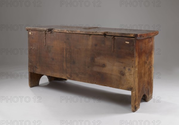 Chest, Gothic style, floral decoration, geometric ornament, repossession, pre-war collection, CHEST with straight sides and front forming console legs at the bottom, with a flat lid, decorated on the pseudo-frame of the front with an engraved decoration featuring a dry thistle motif, with a darkened background. Panels and sides are smooth, without decoration. The lid is framed on the sides and front with profiled frames forming the rim. Board walls, back and front are attached to the body, fastened with dowels. Inside, on the left side of the boxes. Steel fittings, secondary — steel lock, applied, without a cup, strap-eye hinges, fastened with forged nails. Date: 1500–1520. Place of origin: Bavaria, Lesser Poland, Central Europe. Furniture; storage furniture. Dimensions: height 80.5 cm, width 159 cm, depth 60 cm., A wooden chest with a rectangular hinged lid shown from an angled front perspective, made of weathered wood with visible grain, knots, and worn edges, standing on short legs ...