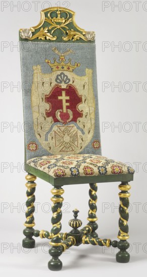 Chair, rosette ornament, coats of arms, crowns, Baroque style, Prus III coat of arms, CHAIR with spirally turned footrest elements, carved, painted, partly gilded and silver-plated, upholstered seat and backrest, upholstered with embroidery on canvas, supported by four straight legs joined by turned links forming an X link at the bottom. The legs terminate in spools at the top, with spherical feet at the bottom, embellished with plant tendrils in the middle. At the intersection of the binding joints, a cube is topped with a turned pinnacle. The backrest is high and rectangular, with a bell-shaped finial decorated with a closed crown, below with crossed palm branches and acanthus leaves, and with shells in the corners; originally with a gap. The backrest rails are angular. The seat features an embroidered net motif, and the backrest features the Prussian coat of arms on a paludament topped with a crown and jewel leg bent at the knee. 1710–1730, Poland; seating furniture; height 141 cm, ...