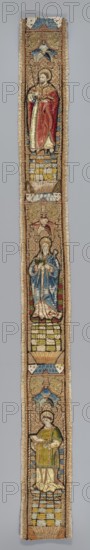 Fragment of embroidery, embroidery, saints: Philip the Apostle, Apolonia St., Szczepan St.; liturgical vestment. One of eight fragments of embroidery from a liturgical vestment with three figures of saints depicted in niches: from the top a saint with a book and spear Maurycy, below a saint with a book and tongs Agata, at the bottom a holy deacon with a book. Embroidery and appliqué on linen canvas. Embroidery laid with gold and silver thread, embroidered with colored silk threads — or nue, and flat, split with silk threads. Floors and architecture columns and vaults on a string base. Colors: gold, sky blue, blue, green, pink, red. 1st half of the 16th century, Netherlands; height 112 cm, width 10 cm., A narrow vertical textile depicting a stacked sequence of three standing figures within ornate framed niches, bordered by a woven trim; the top figure wears a red outer garment over a light inner robe and holds a staff, standing on a patterned tiled platform with blue and yellow tones be...