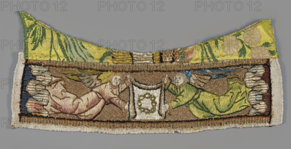 Embroidery, Goluchów Greater Poland Voivodeship, embroidery depicting angels and Instruments of the Passion Arma Christi, crowns of thorns; liturgical vestment. Embroidered parura with two angels in flight holding between them a scarf with the image of a crown of thorns; on the sides a border of strongly wavy clouds. Colors: gold, green, and pink in several tones, blue, burgundy, navy blue. Upper part: remnants of silk fabric brocaded with floral motifs 18th century. Embroidery on linen canvas: laid stitch of gold thread sewn over with red silk thread in a braided motif background, split stitch with silk thread figures, scarf, point d'orient with silk thread clouds. 1st half of the 16th century, Netherlands; liturgical vestment, embroidery; height 7 cm, width 28 cm., A rectangular embroidered textile fragment with a curved top edge showing a group of figures and decorative motifs, rendered in shades of yellow, green, beige, brown, blue, pink, white, black, and grey; the top section has...