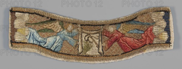 Embroidery, Embroidered parura with a depiction of two angels in flight holding between them a scarf with the image of a whip and a reed; on the sides a border of strongly wavy clouds. Colors: gold, red, blue, navy blue, brown. Techniques: laid stitch with gold thread sewn with red silk thread into a braided motif background; split stitch with silk thread figures, scarf; point d'orient with silk thread clouds. 1st half 16th century, Netherlands; liturgical vestment embroidery. Height 7 cm, width 28 cm., A narrow embroidered textile fragment with a curved top and bottom edge, showing a pair of reclining winged figures facing a central panel; one figure wears a blue garment with green wings and blond hair, and the other wears a red garment with gold wings and blond hair; the background behind them is a patterned gold and brown field; the central panel contains a pale rectangular area with a plant-like motif and adjacent decorative elements; the borders of the fragment feature metallic go...