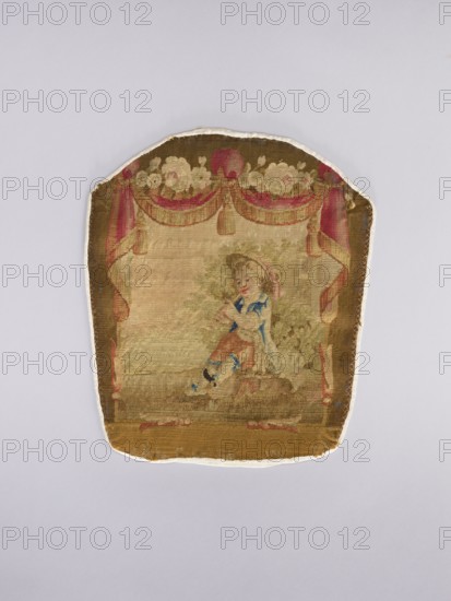 Three tapestry armchair covers, varietals, provenance, flowers, floral ornaments, genre scenes, interior furnishings, garlands, furniture upholstery, decorative fabrics, tapestries; scenes: a boy sitting on a hillock playing a flute, b boy watering flowers, c girl sitting on a hillock; 2nd half of the 18th century; Aubusson; fabrics; height 27.5 cm, width 35 cm., A worn textile panel with a rounded top and straight sides, showing a central painted scene framed by decorative drapery; the top border has a garland of flowers and swags in shades of red, pink, cream, and green against a brown background, with matching red and pink curtain-like vertical elements on the sides; the central area features a seated childlike figure wearing clothing with blue and brown tones and a hat with pink accents, positioned on a muted green and brown ground with surrounding foliage in green and beige; the lower border is a darker brown band with traces of red and pink; the overall colors visible include bro...