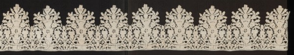 Lace fragment, Floral ornaments; lower edge serrated. In each oval there is a vase of flowers. Flower crowns overlap the serrations. Joined with spiderwebs, so-called Van Dyck. Date: 1630–1650. Place of origin: Flanders. Material: lace. Dimensions: length 200 cm, width 13.5 cm., A horizontal strip of decorative lace displayed against a dark background, featuring a repeating pattern of ornate floral and geometric motifs with scalloped upper edges; the lace is a light creamy beige color contrasted with the deep black background, showing openwork areas and solid embroidered sections that create a symmetrical, rhythmic design with leafy shapes, rounded vase-like forms, and delicate connecting loops.