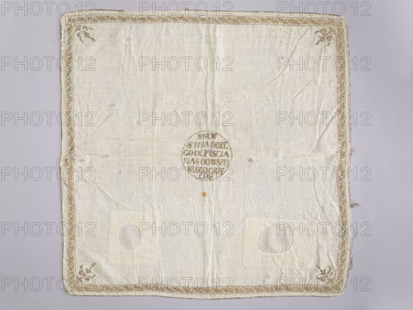 Church napkin made of white batiste density: 34 weft threads and 28 warp threads per 1 cm, embroidered with gold thread on a silk base. Pierced embroidery, in narrow motifs from edge to edge. In the center, in a circle, the inscription: BLOOD / OF THE SON OF GOD / SAVINGS / US FROM ALL SIN. Narrow border with a plant twig motif. In the corners there are stylized bouquets — candelabras. 17th/18th century, Poland. Fabrics, height 65 cm, width 65 cm., Function: church paraments; sacred art; churches and chapels furnishings., A square fabric panel laid flat with a pale cream center and a slightly darker cream border, showing a few faint stains and several small worn spots. The border features a decorative trim in beige and light gold tones that runs along all edges, with a few small floral motifs in brownish-gold at the corners. There are a few patch repairs in a similar cream color near the lower area, each with a circular cutout shape visible on them. The fabric has visible creases and s...