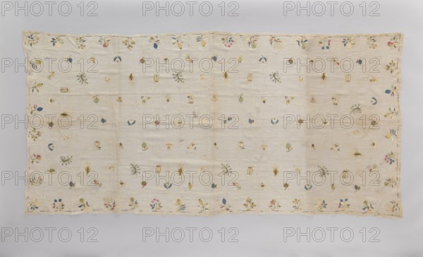Church napkin tablecloth made of very thin linen batiste covered with multicolored silk embroidery. Ornamentation consists of evenly distributed small patterns of stylized flowers, fruit, animals, and birds. In the center are a fox and a rooster, surrounded by blackberries, apples, plums, several varieties of pears, pea pods, acorns, hazelnuts, mushrooms, strawberries, gourds, tulips, lilies of the valley. Border made of a narrow, shaded strip. Flat embroidery, pierced following the motif, double-sided with silk threads in light yellow, light blue, sky blue, blue, pink, celadon, ochre, and gold and silver thread. Early 18th century, Poland. Fabrics; height 210 cm, width 100 cm., A rectangular pale beige fabric laid flat with a scalloped edge and a border of small floral motifs, scattered across the field are a few small embroidered botanical and abstract shapes in colors including blue, green, yellow, pink, and muted gold, with some elements in darker navy and a few touches of soft bro...