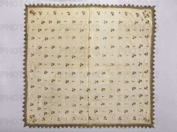 Church napkin made of white batiste density: 31 warp and weft threads per 1 cm, embroidered with gold thread and black silk with small motifs of carnation flowers and cypress, edged with serrations. Chain stitch embroidery, both with silk and gold thread, pierced, single-sided. The embroidery could have been executed on a hoop with a special needle; if so, it would be dated to the 2nd half of the 14th century. Dated 16th/17th century alternative attribution 17th century. Poland. Fabrics. Height 84.5 cm, width 90 cm., A square piece of fabric with a pale cream background and a decorative dark gold scalloped border, the main field patterned with a scattered arrangement of small floral motifs in shades of dark brown and muted gold, showing a central vertical seam and subtle creases and wear across the surface, with the scalloped border forming triangular points at the corners and along the edges against a light neutral backdrop.