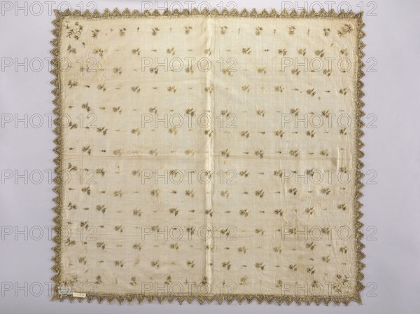 Church napkin made of white batiste density: 31 warp and weft threads per 1 cm, embroidered with gold thread and black silk with small motifs of carnation flowers and cypress, edged with serrations. Chain stitch embroidery, both with silk and gold thread, pierced, single-sided. The embroidery could have been executed on a hoop with a special needle; in that case it would be dated to the 2nd half of the 14th century. Attributed dates: 16th/17th century; also cited 17th century E. Soszko., Function: church paraments/Church napkin. Subject: flowers, leaves, plant ornaments, sacred art. Technique/materials: fabrics, batiste, gold thread, black silk. Place of origin: Poland. Dimensions: height 84.5 cm, width 90 cm., A square fabric laid flat with a delicate triangular scalloped border in a metallic gold color, the main body of the cloth is a pale cream or ivory tone with a subtle sheen and a visible central fold. Scattered across the surface are a few small embroidered floral motifs in mute...