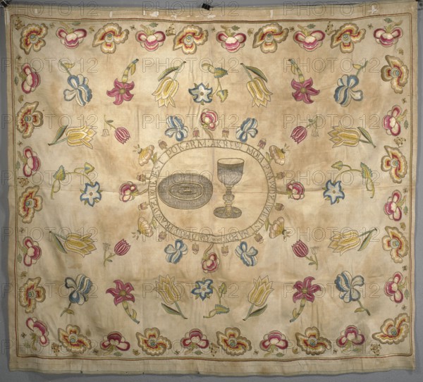 Church napkin of cream now yellowed silk morosa, embroidered with colorful silk threads and metal threads. In the center, in an oval formed by the inscription, chalice and patera, around it are projections of single colorful flowers. Around the oval and edges are flowers on short stems and with fantastic calyxes palmettes?, as well as butterflies, bees, flies; in the background tulips, daffodils, irises and other flowers on longer stems. The border is made of large red-gold flowers, butterflies and other insects. The predominant colors are cream background, magenta, blue in several shades, green, yellow, cream, ochre. Sewn from two pieces of fabric density: 29 warp threads and 24 weft threads per cm. The embroidery is pierced; in the part of the metal threads on the other side only the soul remains, in the part with the inscription the metal thread is on both sides of the fabric. In the center, an inscription in an oval: Jak VI BODY MY TRUE FOOD: AND BLOOD MY TRUE DRINK:. Early 18th ce...