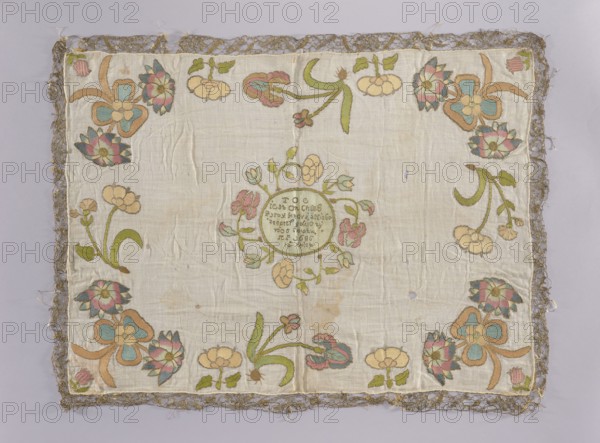 Church napkin vellum? made of white linen batiste embroidered with multicoloured silk threads. In the center, in a circle surrounded by a wreath of large flowers, there is an inscription: TOC/ IEST ON CHLEB/ ZYWY. WOTY NIEBA/ ZTAPIEJ Y DAJE ZYWY/ WOT WWIATU/ RP 1686/14 KWIET. Along the edges are large flower sprigs, including irises. The edges are trimmed with gold bobbin lace. The dominant colors of the ornament are blue, pink, sand, and gold. Batiste: 22 warp and weft threads per meter. Double-sided flat embroidery, pierced, very fine stitches. Embroidery with silk yarn and threads with a metal braid in silver and gold on a silk base. Flat and split stitches. 1686, Poland. Fabrics; height 63 cm, width 86 cm., A rectangular textile with a pale cream background is shown, bordered by a metallic lace trim in a muted gold color. A decorative floral design is embroidered near the edges and in a central circular motif, featuring a palette of soft colors including light green, muted teal, du...