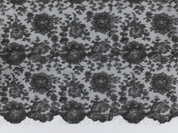 Shawl, shawls, floral ornaments, clothing accessories, women's clothing, fashion, Pattern on a mesh background, reported. Long edges: upper - sewn-on narrow stripe made using the bobbin technique, lower serrated, without distinctive edge ornament. Short sides of the shawl cut off and left unfinished. 1st half of the 19th century, France, fabrics, length 245 cm, width 100 cm, A patterned piece of fabric with a repeating floral lace design spread flat, showing a sheer background with darker floral motifs and leafy vines; the lace edge along the bottom has a scalloped outline with larger flower shapes, while the interior features a dense arrangement of roses and smaller blossoms connected by thin stems. The visible colors are black and light gray.