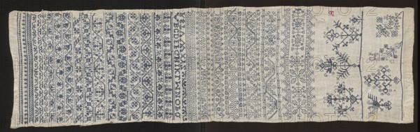 Embroidery sampler, Sampler with a cross-stitch pattern with motifs of trails, flower bushes, and letters. Blue embroidery on white canvas. Trails of geometric and floral ornaments with geometrized twigs and leaves. On one edge are several larger motifs in the form of stylized flower bushes. In the corner, the silhouette of a double-headed eagle. Between the paths, next to geometrical flower tendrils of various types, there is a double Holbein stitch ornament. 17th century, Silesia. Embroidery on fabric; height 81.5 cm, width 23 cm., A long rectangular textile laid flat on a dark background, showing a woven light beige or off-white base with many horizontal bands of intricate embroidery in blue thread and a small area with faint red and yellow stitches; the embroidered bands contain repeated geometric and floral motifs, including rows of small flower-like shapes, interlocking patterns, and stylized vine or branch elements, with one end featuring larger symmetrical floral or tree-like d...