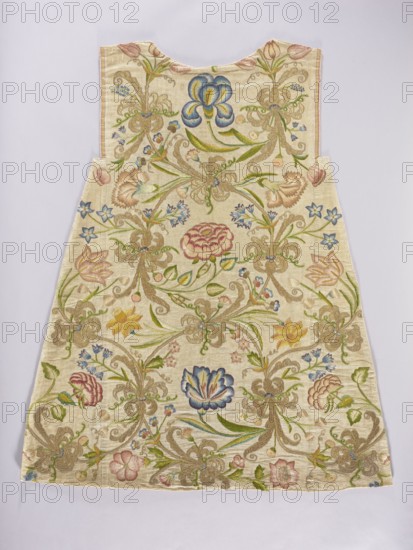 Two fragments of a dalmatic, front and back, of silk fabric interwoven with silver thread. Embroidery depicts a floral tendril with tulips, bellflowers, pansies, carnations, daffodils, irises, and roses with species-appropriate leaves, plus golden fantastic flowers with bent stems. Predominant colors: yellow several shades, blue, pink, red, green, and gold. Materials and techniques: metal thread embroidery gilded silver plate woven on a silk base and multicolored silk; gold embroidery with a laid flat stitch, metal threads held with silk yarn; silk embroidery with satin and split stitches. Fabric: silver lamé grosgrain interwoven with silver thread. Gauge width: 50.5 cm; yellow-red selvedge; density 17–18 weft threads per cm2, 14–15 warp threads per cm2. Dating: 18th century embroidery, 16th century fabric. Places of origin: Poland embroidery, Italy fabric. Function: liturgical vestment. Dimensions: length 104.5 cm, width 87 cm., A sleeveless garment shaped like a trapezoid with a shal...
