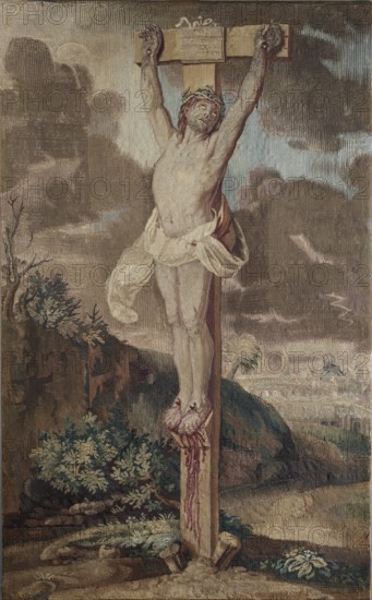 Tapestry, Studio of François Glaize after Anton van Dyck, ca. 1743–ca. 1770. Crucifixion: In the center, Christ on a cross with a short crossbeam, arms raised upward; the perizonium is blown by the wind. Legs nailed with two nails, supported by a footrest. A tablet tied to the cross reads JESUS NAZARENUS REX JUDEORUM. To the left, a fragment of land with bushes; next to the cross a rock with vegetation. In the distance on the right, a landscape with urban buildings Jerusalem on a high horizon under puffy dark gray clouds. No border. Colors: dark green, brown, sand, with accents of beige, blue, and green. 1st half of the 18th century, Poland. Fabric; height 96.5 cm, width 58.5 cm., A painted scene of a lone male figure on a wooden cross, wearing a pale cloth around his waist and a crown on his head, arms outstretched and head tilted; his feet are bound to the cross with visible wound details and red markings. The cross stands on rocky ground with some green foliage and bushes nearby, an...