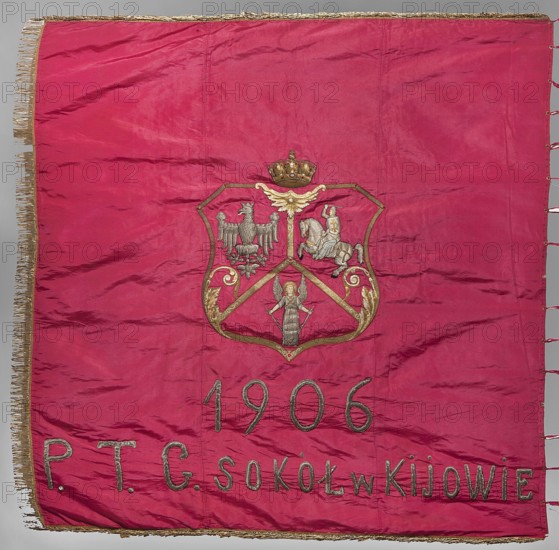 Banner of the Sokól Gymnastic Society in Kiev, banners, origin unknown, Polish Gymnastic Society Sokól 1867-, vexils, White Eagle coat of arms, Pogon coat of arms, Kiev Ukraine, double-sided banner. Front: blue with red grosgrain with a three-field coat of arms under a crown; top right: White Eagle, left: Pogon, below them: Angel with sword and shield coat of arms of Kiev Voivodeship. Under the coat of arms embroidered inscription 1906/ PTG Sokól w Kyjowie. Reverse: white beige background with silhouette of a falcon with spread wings against a flowing silver ribbon; top of the ribbon embroidered in red thread W ZDROWEM, bottom IELE SILNY DUCH. Banner trimmed on three sides with gold bullion fringe. One vertical side has magenta ribbons threaded through metal rings for tying the flagpole 12 pcs.. 1906, Kyiv; fabrics; height 157.5 cm, width 157.5 cm., A large rectangular fabric panel in a rich magenta color with a decorative golden fringe along the top and left edges and small magenta lo...