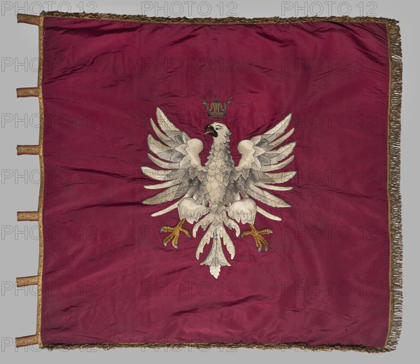 Double-sided banner, vexillium; double-sided banner with insurgent symbols. On the main white side, at the top center, there is a small applied jacquard image of Our Lady of Czestochowa; below is an embroidered inscription CZUWAJ; beneath that, against the background of crossed scythes standing upright, a Maciejówka cap with peacock feathers. On the reverse, a white eagle under a crown embroidered on a red background. Edge trimmed with gold fringe. Embroidered fabrics, fabrics; 2nd half of the 19th century; Poland. Height 115 cm, width 122 cm., A square cloth in deep red with a group of fringes along two adjacent edges and a narrow decorative border along the other edges; at the center is a large embroidered bird with outstretched wings in shades of white, gray, and light brown, detailed feathering, a darker beak and a small crown above its head, and talons colored in yellowish brown.