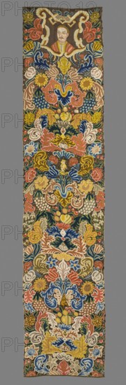 Tapestry, Tapestry embroidered in wool and silk on linen canvas. In the upper part, within a decorative cartouche, is the bust of a nobleman in a zupan and kontusz, with a mustache and shaved hair. Around it are dense scrolls of large leaves, flowers, and fruit. Among them, in the center, is a small boy in uniform, and below, an animal with hooves. No border. Vivid colors: brown background, pink, sapphire, green, yellow, ochre ornament. Plant motifs of the nine fabrics comprising this ensemble are similar: stylized leaves, flowers, and fruit filling the surface. The composition unfolds on both sides of the axis, defining a symmetrical decoration, similar to large-patterned silk upholstery fabrics fashionable in the late 17th and early 18th centuries. Minor differences include small animal silhouettes. All fabrics show the same fruit: plump bunches of black and white grapes, yellow apples, and dark red cherries. Vivid colors, brown background, shaded ornament: pink, sapphire red, blue, ...