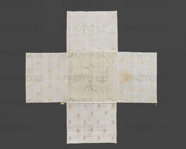 Church napkin. Church napkin of thin white linen, sewn from five rectangular pieces of fabric in the shape of a cross. Embroidered with evenly spaced projections of stylized floral sprigs in gold, dark pink, and straw. One side rectangle bears an embroidered gold IHS monogram within a halo; the opposite rectangle, on the edge, has the inscription ANNA Z RUSOCKICH ORZECHOWSKA. R. 1743. 1743. Poland. Fabrics. Height 290 cm; width 290 cm. Creator: Anna Orzechowska née Rusocka 18th century; fl. ca. 1743. Function: church paraments / sacred art; furnishings for Evangelical churches. Subjects: flowers, leaves, plant ornaments., A cloth arranged in a cross-like shape on a dark gray background, made of lighter fabric panels with a woven texture; the fabric is mostly off-white or cream with a few small yellow floral-like motifs scattered across several panels, one panel showing a sunburst motif in yellow, and another lower panel featuring faint pink floral motifs; the central area of the cloth ...