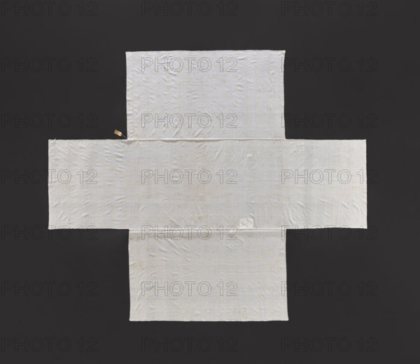 Church napkin, church paraments; Evangelical church Sielec furnishings. Embroidered thin white cotton fabric with fine floral pattern in yellow and gold; edged on one side with a very narrow strip of plant twig motif in yellow and gold. Flowers, leaves, plant ornaments; sacred art. 1st half of the 18th century, Poland. Height 327 cm, width 280 cm., A flat rectangular textile arranged in a cross-like shape on a dark background, the fabric appears off-white with a subtle woven texture and small scattered lighter spots; the cloth shows soft wrinkles and a few faint irregular marks, and there is a small rectangular lighter patch near the center; the background is a deep dark gray.