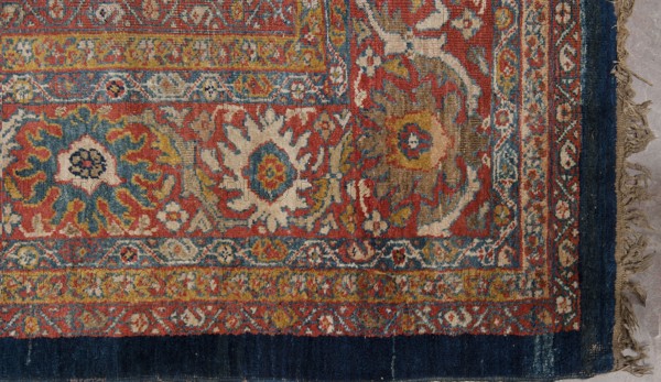 Carpet, The main field is filled with motifs of various species of trees arranged in three vertical rows; between the trees are flower bushes, palmettes, and small rosettes. Seven-strip border with plant ornament. Colors: navy blue, red, yellow, cream, navy blue, blue and red. A similar carpet contains in the central field a section of a similar garden 1/4 with almost identical motifs in reversed colors, dark brown with a navy blue outline on a sandy background. It is dated to the 18th century and knotted in northwestern Persia Kurdistan. Cotton warp, S7Z; symmetrical Z2S wool knots, density approx. H27 x W26 ˜702 knots/dcm2. The rectangular section contains motifs of stylized weeping willows, cypresses, flowering trees pomegranate, lotus palmettes. 19th century, Iran; woven fabric. Height 512 cm, width 430 cm., A section of a patterned woven rug with ornate floral and geometric motifs in a palette of red, blue, cream, yellow, and brown, featuring a dark blue fringe border along one ed...