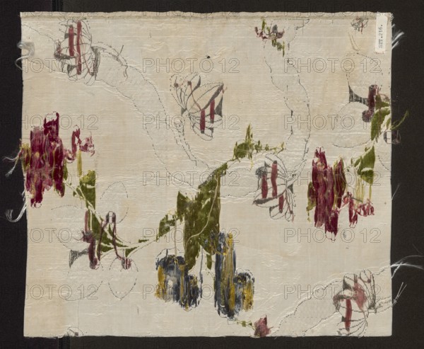 Fabric fragment, fragments of silk fabrics, patterned brocaded silk, 2nd half of the 18th century, England, fabrics with preserved selvedge, height 31 cm, width 27.5 cm. Weave structure: background - plain weave with a grosgrain structure, liseré pattern sub-weave, brocaded. Pattern: floral motifs developing around a winding silver ribbon; fanciful flowers resembling roses and polka dots; winding lace-ribbon motif with delicate twigs entwining it. Background light with a liseré effect, brocaded with colorful threads and silver lamellar and tightly braided silver thread. Overlay for the meandering pattern formed by tiny leafy branches and ribbons crisscrossing and waving opposite to the main ribbons. Brocade threads: light and dark blue, light and dark pink, yellow, white, light and dark green, two types of metallic threads, and a sorbec thread with a pink core. Colors: white background; pattern in celadon green, pink, pale blue, lemon, yellow, brown, burgundy, grass green, white, heath...