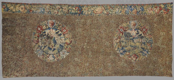 Tapestry, late 16th century, Flanders. Fabric fragment: entire background densely strewn with motifs of small flowering plants millefleurs. At the upper edge, two medallions with landscapes inside, their borders formed by floral and grotesque motifs; above them a border with motifs of flowers, fruit, and leaves. Decorative tapestry with flowers, fruit, medallions, and landscapes. Colors: black background, red, green, dark navy, and sand ornament. Materials: fabrics. Dimensions: height 167 cm, width 365 cm., A large rectangular textile with a dense floral field in muted green, brown, red, blue, cream, and gold tones, featuring two large circular medallions set within the patterned background; each medallion contains a scenic vignette in blue, cream, green, and beige hues surrounded by decorative floral borders in red, blue, cream, yellow, and green, and topped by a small mask-like face in cream and brown; a wide floral border runs along the top edge with stylized flowers and leaves in b...