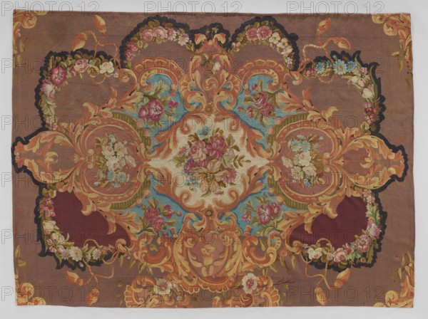 Ornamental tapestry, Cut from a larger piece; in the center, a bouquet of flowers in a medallion made of acanthus leaves. Around it are similar medallions and cartouches with flowers or flower clusters in the center. No border. Colors: plum background, ornament in pink, lilac, blue, green, cream, yellow, and black. 18th/19th century, France. Fabrics. Height 320 cm, width 234 cm., A rectangular decorative textile with an overall brown background featuring an ornate symmetrical central medallion in shades of cream, orange, and blue, surrounded by scrolling acanthus-like shapes in warm oranges and golds; the design includes a group of floral sprays with roses and other blossoms in pink, red, cream, and blue with green leaves, set against areas of deep burgundy and turquoise accents, and edged with darker scalloped outlines in navy and black, with smaller floral garlands and ribbon-like motifs in yellow and orange woven throughout.