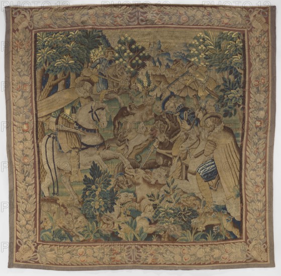 Figural tapestry, provenance unknown. In the foreground at the edge of a forest, among low vegetation, dogs attack a wild boar. Above, horseback riders with sabers or rifles. In the distance, urban buildings and a castle on a hill. Border with a motif of densely interwoven flowers and leaves. Motifs: flowers, floral ornaments, dogs, hunting, hunters, trees, horseman, forests, weapons. Materials: woven fabric. Colors: brown, green, beige, red, and gray. Date: 2nd half of the 17th century. Place of origin: Flanders. Dimensions: height 287 cm, width 291 cm., A woven textile showing a scene with several human figures wearing elaborate period clothing and hats, mounted on horses and standing among foliage and animals, including dogs and other creatures; the central area contains trees and shrubs with dense leaves in shades of green and blue, and ground vegetation in green and muted brown; the figures and horses are rendered in tones of beige, tan, brown, blue, and hints of gold, with some g...