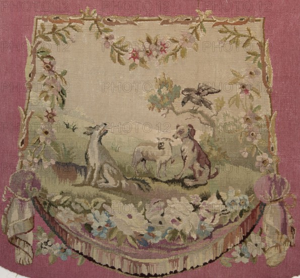 Tapestry armchair seat cover, Wool tapestry with figurative motifs: dogs, birds including a raven, trees, draperies below, and surrounding flowers. Colors: beige, light brown, pink, blue, and green. Post–mid-18th century, possibly Aubusson or Beauvais origin. Materials: fabrics; height 57.5 cm, width 67 cm., A woven tapestry panel with a central rectangular scene set against a dusty rose background, featuring muted beige, cream, green, brown, pink, blue, and gold tones; the central scene shows a pastoral landscape with grassy greens and soft beige sky, a few flowering vines and leaves framing the top and sides in pale pinks, greens, and golds, and a group of animals in the foreground including a reclining greyhound-like dog in grey and white, a seated brown-and-white dog, and a sheep in cream and light brown; a stylized tree with olive green and brown foliage appears to the right with a perched bird in dark brown, and floral swags and a gathered drapery border in cream, pink, blue, and...