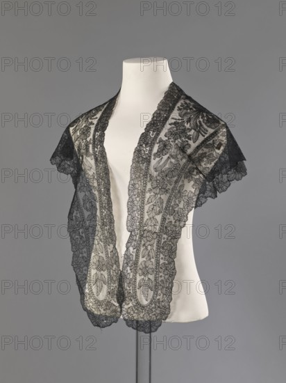 Mantilla, purchase provenance; floral ornaments; Chantilly lace; lace; clothing accessory; women's clothing; fashion; mantillas; triangular with highly raised upper corners; 2nd half of the 19th century; France; height 36 cm, A white mannequin torso displays a delicate black lace shawl with intricate floral and leaf motifs, scalloped edges, and a sheer net background; the lace drapes over the shoulders and down the front, creating layered translucent patterns against the smooth white surface, with the overall scene set against a neutral gray backdrop.