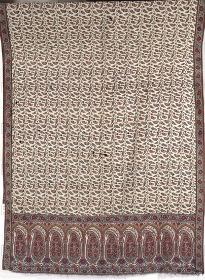 Shawl, bota ornament, plant ornaments; women's fashion accessory; 19th century; India, and Iran ; clothing accessory; length 134 cm, width 308 cm., A large rectangular textile with a cream background covered by a repeated small floral vine pattern in red, blue, and dark green, framed by narrow decorative side borders in red and blue, and a wider decorative lower border featuring a row of arch-shaped panels filled with intricate floral motifs in red, blue, green, and brown, with additional circular floral medallions along the top of the lower border.