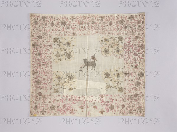 Velum;, Velum or church cloth of white linen, embroidered with silk and gold thread. In the centre is a Lamb with a labarum and a chalice, into which blood spurts from its breast. Around the edges is an elaborate plant twig with motifs of grapes and flowers; floral motifs are featured in the corners of the central field. Embroidery with pierced silk and metal thread, using cord and satin stitches; some metal thread elements are worked on colored silk backing. Metal thread is silver plate woven onto a silk or linen base. Revindication, 16th century, Silesia. Liturgical vestment. Height 63 cm, width 70 cm., A square piece of fabric laid flat with a pale off-white center and a decorative border showing floral vine motifs in pink and muted gold tones, with areas of darker grayish-black detailing; near the center a small dark gray figure resembling an animal stands against the lighter background; the border contains a repeating pattern of stylized flowers and curling stems in pink, gold, an...