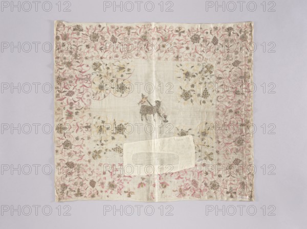 Velum, Velum or church cloth of white linen, embroidered with silk and gold thread. In the centre is a Lamb with a labarum and a chalice, into which blood spurts from its breast. Around the edges is an elaborate plant twig with motifs of grapes and flowers. In the central field, floral motifs are featured in the corners. Embroidery with pierced silk and metal thread, with cord and satin stitches. Some metal thread embroidery elements are made on a colored silk backing. The metal thread is a silver plate woven onto a silk or linen base. Revindication, Church paraments; Eucharistic Lamb iconography; churches and chapels furnishings. 16th century, Silesia. Liturgical vestment. Height 63 cm, width 70 cm., A square piece of thin fabric laid flat with a pale off-white center and a decorative border, featuring a continuous floral and vine pattern in pink and muted gold tones around the edges; a darker small animal-shaped motif appears near the center in a grayish-brown color, and a rectangula...