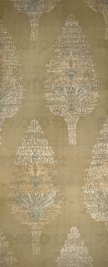 Three fragments of a chasuble, fabrics, silk, patterned, Persian, Iran, plant patterns. Three light-yellow brocaded fabric fragments parts of a chasuble with motifs of cypress trees filled with a stylized lily flower. Pale yellow grosgrain background; pattern brocaded with metal thread and silk yarn in green, celadon, pink, and orange. Dimensions reported: 49 x 16? cm; overall height 95 cm, width 24 cm. 18th century., A vertical textile with a repeating ornate motif resembling elongated teardrop or tree shapes in a soft beige background; the motifs are rendered in pale cream and off-white with accents of muted blue and light gold, showing intricate woven details and stylized floral elements, and the fabric surface displays subtle horizontal and vertical weave texture throughout.