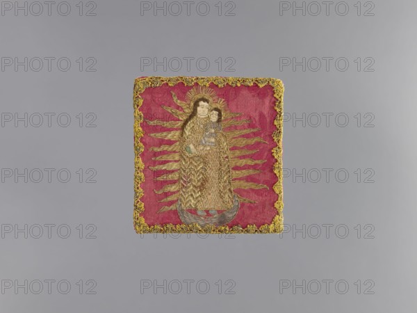 Pall, embroidery, church paraments, plant ornaments, sacred art, churches and chapels furnishings. Pall of dark red damask with a floral pattern, embroidered with silver and gold metal braid threads and silk yarn. In the center is a standing figure of Mary and Child with a crescent moon under her feet, surrounded by a radiant halo. Predominant colors: red, gold, silver, green, brown, and blue. The edges are trimmed with narrow gold bobbin lace. White linen lining. Early 18th century, Poland, liturgical parament. Height 13 cm, width 12 cm., A rectangular embroidered textile with a deep pink background and a gold decorative border surrounds a central figure. The central figure is made with gold and brown thread and has lighter skin tone details on the face and hands; the figure appears to be holding a smaller figure similarly rendered with gold and pale skin tones. Radiating gold rays extend outward from behind the figures against the pink background. There is a crescent-shaped base bene...