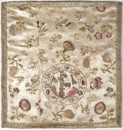 Velum made of three fragments of white cream satin, embroidered. Below half the height in a medallion is a depiction of Christ at a column Flagellation of Christ iconography, framed by floral sprigs. Background with motifs of floral sprigs of various sizes, including tulips, roses, peonies, chrysanthemums, lilies, lilies of the valley, and sprigs with berries and wild strawberries. Embellished with gold galloon. Lining made of plain-weave cotton fabric. Flat embroidery with silk yarn in satin, cord, and banner stitches, as well as gold and silver metal thread in a laid stitch. Silk yarn in red, cream, yellow, blue, purple, white, and green. 18th century, Poland; liturgical vestment, fabrics. Height 52 cm, width 49 cm., A square textile with a cream background bordered by a gold fringe, featuring embroidered floral motifs in shades of gold, pink, burgundy, green, blue, and brown scattered across the surface; a circular embroidered medallion near the center contains a figural scene worke...
