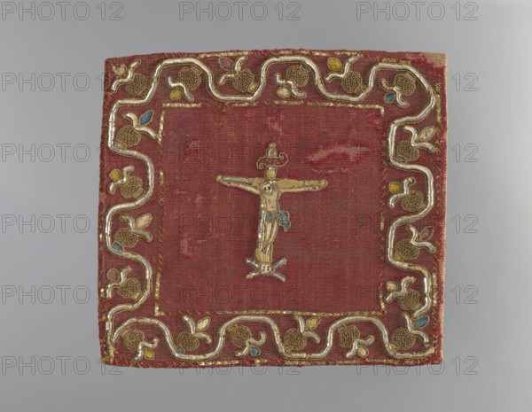 Pall, Christ Crucified iconography, embroidery, church paraments, plant ornaments, sacred art, churches and chapels furnishings. Pall of cherry-red silver-plated silk fabric. In the center is an embroidered figure of Christ on the cross. Below the cross is a skull with crossbones. Around the edges is a wide border with a simplified twig motif with fruit or flowers. Green silk lining. Embroidery executed with silk yarn in a satin stitch on a low thread base linen and silk and metal threads plate braided on a silk core in a flat and loop laid stitch metal thread arranged in loops held by silk yarn. Embroidery with a metal plate laid flat and held in a cross-stitch manner with silk yarn and placed on a silk base and a linen string base description of the embroidery technique. 16th/17th century, Poland, liturgical vestment, height 19 cm, width 21 cm., A square textile with a worn red background features a central embroidered figure on a cross in metallic gold and pale beige threads with a ...