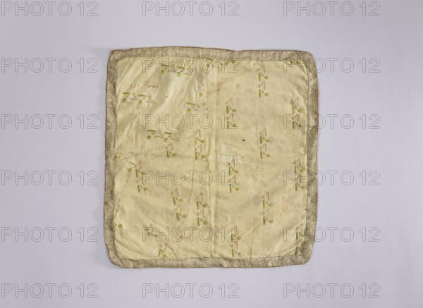 Velum; creator, author, provenance, church paraments; flowers; leaves; plant ornaments; sacred art; churches and chapels furnishings; 2nd half of the 18th century; place of origin, liturgical parament; height 42 cm; width 45 cm, A square fabric piece with a pale yellow center and a thin decorative border in a muted gold tone, laid flat on a light gray background; the center shows a repeating small motif in shades of green and light pink scattered across the surface, with visible creases and slight discoloration in places, and the border appears textured and slightly darker than the pale yellow interior.