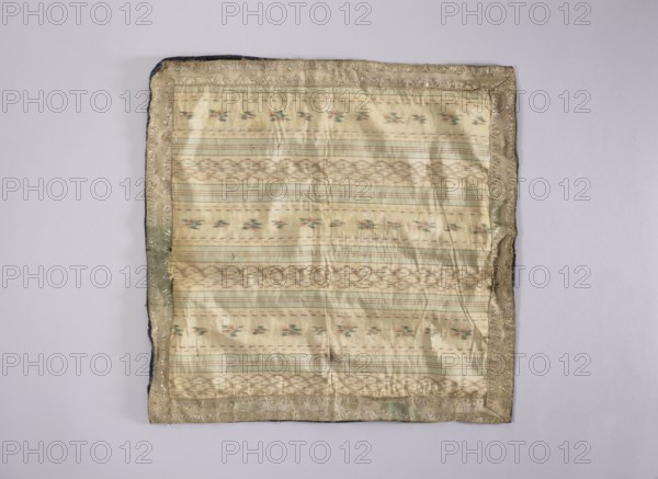 Velum; unknown creator; church paraments; revindication provenance; flowers, leaves, plant ornaments; sacred art; churches and chapels furnishings; 18th century, France; liturgical parament; height 47 cm; width 47 cm, A square fabric with a pale cream and light beige woven center showing horizontal striped patterns and small floral-like motifs in muted green and soft pink, surrounded by a narrow metallic-looking border in a tarnished gold color with areas of darker olive and hints of navy along the outer edge, all placed on a plain light grey background.