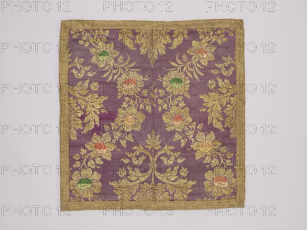 Velum, vellum, church paraments, provenance noted, floral ornaments, satin vellum with floral ornament, late 19th century, Russia, Germany, liturgical parament, height 43 cm, width 42 cm, A square piece of textile with a purple background and a wide gold border, decorated with an ornate pattern of gold scrolling leaves and floral motifs; several flowers within the design have petals in shades of gold and centers in green and orange, and the overall surface shows subtle variations in purple tone.