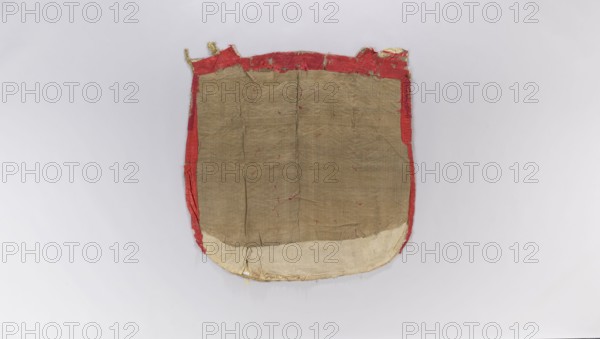 Church cope, church copes; liturgical vestments decorated with flowers, leaves, and plant ornaments; church paraments; sacred art; furnishings for churches and chapels; 18th century, France; height 140 cm; width 136 cm., A roughly rectangular fabric piece with rounded bottom edges, showing a central tan or beige panel bordered by a red strip around the sides and top and a lighter off-white curved section along the bottom; the fabric surface is wrinkled and worn with small loose threads and frayed edges, and the red border appears torn in places revealing some pale yellowish material beneath, all set against a pale gray background.