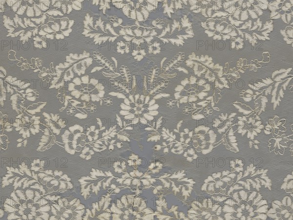 Shawl, shawl, clothing accessory, women's clothing, fashion, lace, serrated edges, in their bends twigs with two flowers, in the middle part curling flower twigs, 19th century, Europe, length 48 cm, width 260 cm, A patterned fabric with a repeating floral lace design in off-white thread on a gray background, showing a delicate mesh base and ornate embroidered flowers, leaves, and vines, with scalloped motifs and varied petal shapes creating a textured, layered appearance; visible frayed edges in places and subtle variations in thread thickness, with the predominant colors being gray and off-white.