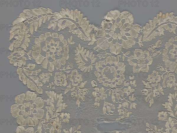 Shawl, shawls, clothing accessories, women's clothing, fashion, lace with serrated edges, design of twigs with two flowers in the bends and curling flower twigs in the middle part, 19th century, Europe, length 48 cm, width 260 cm, purchase provenance., A delicate lace fabric laid flat against a gray background, showing an intricate floral and leaf pattern with openwork sections and scalloped edges; the lace appears in shades of off-white, cream, and light beige with subtle darker beige discolorations in a few areas, and the background is a uniform gray.