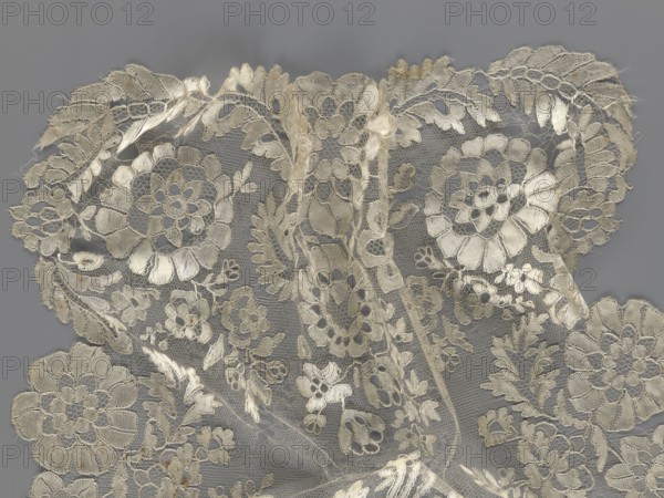 Shawl, shawl, clothing accessory, women's clothing, fashion, lace, serrated edges, in their bends twigs with two flowers, in the middle part curling flower twigs, 19th century, Europe, lace, length 48 cm, width 260 cm, A delicate piece of lace fabric fills the image, showing an intricate floral pattern with large and small stylized flowers, leafy vines, and scalloped edges; the lace is rendered in pale cream and off-white tones against a medium gray background, with fine netting visible between the embroidered motifs and areas of slightly frayed thread along some edges.