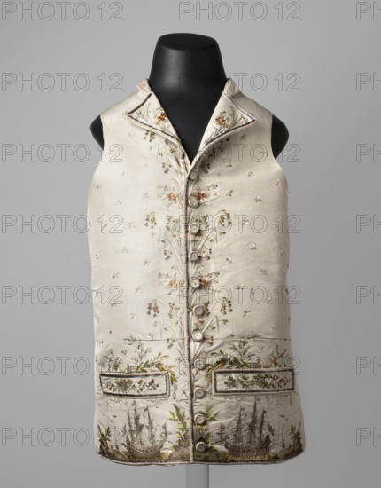 Vest, ships, seascapes, shells, plant ornaments, fashion, men's clothing. Vest made of cream silk grosgrain, straight cut, collarless, with flaps, fastened with covered buttons at the bottom marked by pocket flaps. Richly embroidered front, laced canvas back, silk lining. Embroidery background with small floral motifs; along the fastening are flower sprigs and grass. Chains around the pockets; above the pockets are flowers, a fragment of a stork's nest, and a seagull. Sea vegetation and shells adorn the pocket trim. Beneath the pockets is a fragment of a seascape with two three-masted ships and a small ship in the background. Flat embroidery using satin, laid, and knotted stitches; untwisted and twisted silk yarn. Predominant colors: green, gray, and salmon. 1780s, Silesia and France, garment, length 70 cm., A sleeveless, waist-length garment displayed on a black mannequin, made from a light-colored fabric with delicate floral embroidery and decorative stitching; the front has a row of...
