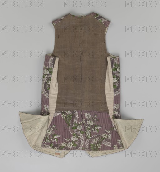 Vest, floral ornaments, patterned fabrics, Fastened to the neck with 11 buttons. Flaps on the sides, below them 4 buttons as for the fastening, embroidered in gold. The back is made of brown canvas at the top and fabric at the bottom as on the front. 1750s, Silesia, garment, length 76 cm, A sleeveless garment laid flat showing the back with a central panel of coarse brown fabric flanked by inner panels of light beige and outer panels of patterned fabric; the patterned fabric is mauve with vertical lighter stripes and floral motifs in white and green, and there are sections of off-white lining visible at the turned-out edges; overall colors visible include brown, mauve, off-white, white, green, and a hint of darker brown in the stitching.