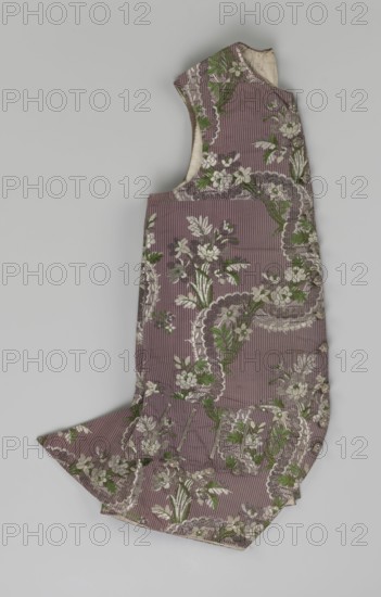 Vest, floral ornaments, patterned fabrics, Henryków German: Heinrichau — museum repository, fastened to the neck with 11 buttons; flaps on the sides with 4 buttons below for fastening; embroidered in gold; back made of brown canvas at the top and fabric at the bottom as on the front; 1750s, Silesia; garment; length 76 cm., A single sleeveless garment laid flat against a pale gray background, made from a ribbed fabric in a muted mauve color with a floral brocade pattern; the floral motifs are in shades of white and cream with green leaves and darker taupe or brown ornamental borders, and small round fabric-covered buttons run along one side; the garment has a curved neckline and an extended skirt-like lower section with pleated or flared panels, and the inner lining visible at the neckline is an off-white or cream color.