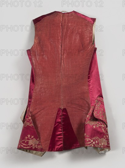 Vest, floral ornaments, Henryków German: Heinrichau - museum repository, clothing, men's clothing. Men's vest made of cherry satin, embroidered. Straight cut, without sleeves or collar. Diagonal hemline, side pockets covered with large flaps, three covered buttons under each flap. Fastened to the neck with 11 covered and embroidered buttons. 1740–1770, Silesia. Length 78 cm., A sleeveless garment displayed against a pale gray background, primarily showing a faded reddish fabric on the back panel with visible wear and texture, flanked by deeper rose and rich magenta satin side panels; the lower sides and hems feature ornate embroidery in a gold tone on magenta fabric, and the interior edges reveal a muted beige lining.