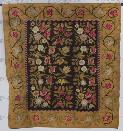 Kilim, 19th century, Poland. Flatwoven decorative textile kilim with central field of intertwining floral branches: three motifs on the sides forming a square and two narrower central bands forming rectangles. Surrounded by a wide border with a floral tendril motif, separated from the main field by a narrow trail of diagonal stripes. Colors: central field background brown, borders yellow; ornament in red, green, and beige. Dimensions: height 190 cm, width 207 cm., A rectangular woven textile with a dark central field filled with a repeating floral pattern and a wide golden border; the central area shows a dense arrangement of stylized flowers and leaves in shades of pink, rose, cream, pale yellow, olive green, and muted green on a deep dark background, with stems and foliage creating vertical and diagonal groupings; a narrow striped inner frame in alternating pink and teal separates the central panel from the border; the broad outer border is golden ochre with a sinuous vine motif bear...