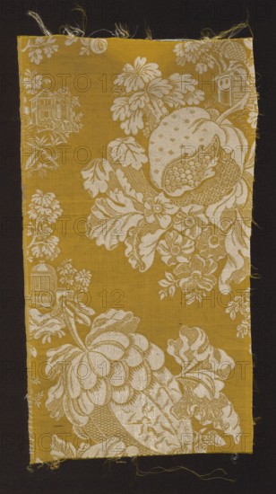 Fabric fragment, fabrics, 18th-century silk fabrics, fragments of silk fabrics, patterned fabrics, chinoiserie, plant patterns, patterns with architectural motifs, fabrics with preserved selvedge. A type of two-tone damask in yellow and white. Background: gros de Tours yellow main warp, yellow binding warp; pattern: plain weave white leading wefts, white binding warp. Design: motifs of flowers and large stylized fruit between which are placed fragments of miniature architecture; chinoiserie-type pattern composition. The fruit resembles quinces in shape. Background - yellow, pattern - white. Border width: 0.4 cm. The fabric pattern is characteristic of the period of the 18th century, 1730–1740, France. Height: 40.5 cm, width: 21 cm., A rectangular textile fragment with a mustard yellow background features an ornate off-white floral and fruit pattern showing large stylized blossoms, leaves, and a segmented fruit, with smaller blossoms and foliage filling spaces; a few architectural motif...