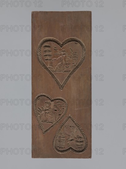 Double-sided gingerbread mould. Obverse: three hearts formed with laurel leaves, each containing an allegorical scene of female figures in a garden among trees — first: standing woman in a long dress holding a wreath beside a small garlanded altar; second: seated woman in a long dress among bushes and flowers leaning on a pedestal, with a flying bird to her right; third: seated woman in a dress reading a letter, next to a musical instrument zither?. Reverse: laurel-wreathed heart containing an altar in a garden with a heart pierced by an arrow, above it a sun and two birds. Decoration includes a fan and various architectural elements. Gingerbread mould, figurative folk motifs, decorative art; rectangular double-sided form. Materials: gingerbread form. Origin/provenance: Silesia Province of Silesia, Prussia, 19th century Province of Silesia 1742–1918. Dimensions: height 31 cm, width 12.7 cm, depth 3 cm., A tall rectangular wooden board in brown with a smooth surface shows three heart-sh...